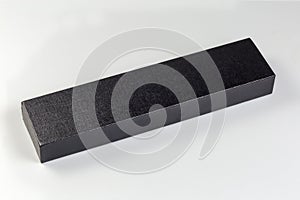 Small black long rectangular cardboard box with closed lid