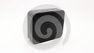 A small, black portable speaker