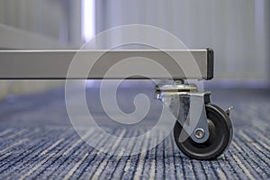 Small black rubber wheel on the carpet.Office abstract background