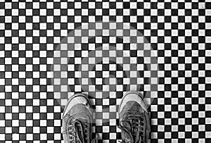 Small black and white tiled floor with shoes