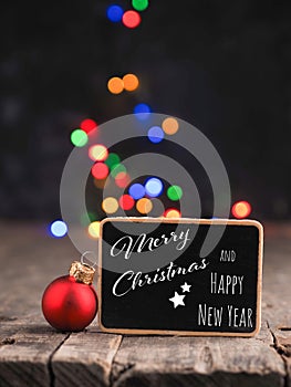 Small blackboard with the inscription Merry Christmas and Happy New Year