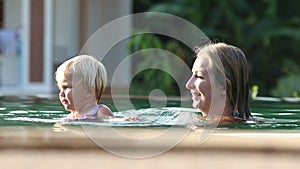 Small Blonde Child Swim with Mother