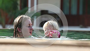 Small Blonde Child Swim with Mother