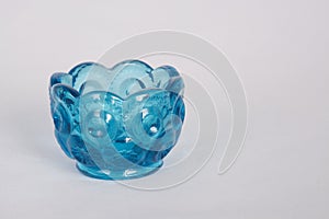 Small blue glass bowl on white