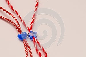 Small blue heart and star on red and white bakers twine with white background