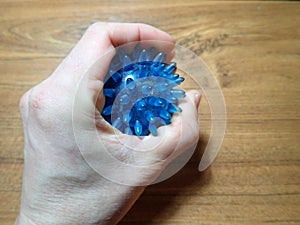 Small blue physiotherapeutic ball for hand