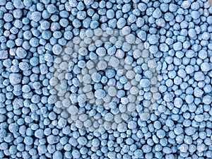 Small blue round granules are chemical fertilizers