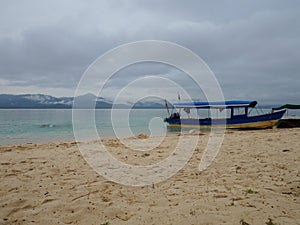 Small blue rustic boat on San Blas islands beach photo