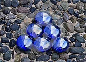 Small blue triangle on pebblestone background