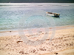 Small boat anchored off a Seychelles beach