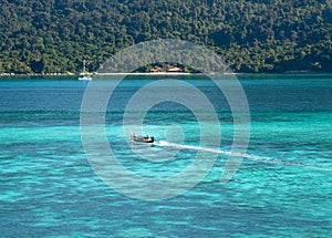 Small boat with blue sea