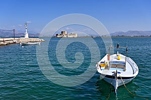 Small boat and Bourtzi fortress in Nafplio, Peloponnese photo