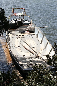 small boat in China pushed up on land