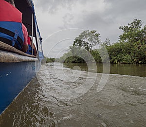 Small boat cruises the Carti river on its way to San Blas in Panama central America photo