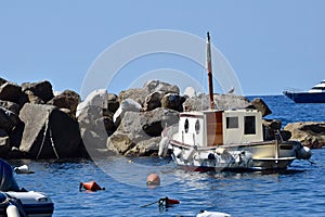 Small boat is docked in a harbor