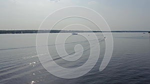 A small boat floats on the lake. Beautiful view from the air.