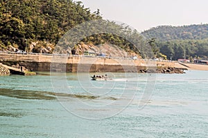 Small boat full of fishing nets coming into port