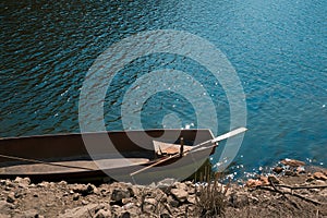 Small Boat on the lake with an oar