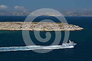 Small boat leaving fortress If next to harbor of Marseille