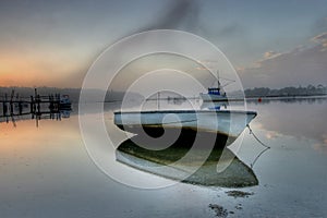 Small boat at low tide