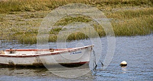 Small boat moored in a river bed