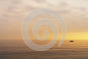 small boat at nachor in a calm ocean at sunset