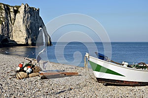 Small boat on pebble beach of Etretat in France