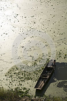 A small boat in the pollutional river