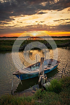A small boat in a salt water lake at sunset near Montpellier, France