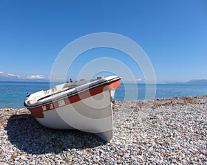 Small boat on sunny beach