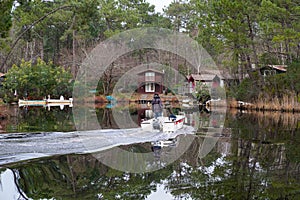 Small boat in water bay Marina de Talaris on Lake Lacanau