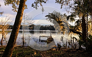 Small boating dock in St Johns river in Florida during sunset