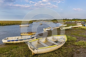 Small boats beached on the banks of the River Glaven, Norfolk