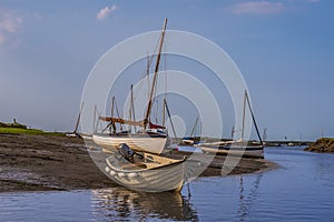 Small boats beached at Morston Creek, Norfolk at low tide