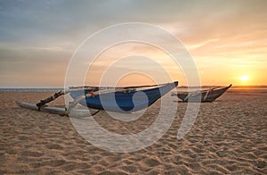 Small boats on an empty beach at sunset, Sri Lanka