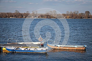 Small boats, fisherman ships anchored standing on the riverbanks of the river Dabube on Zemunski Kej, in Zemun, a suburb of