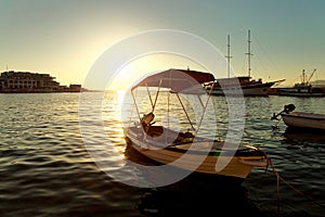 Small boats, fishing trawler and a sailboat moored in the harbor of a town Postira - Croatia, island Brac