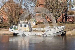 Small boats are moored near river coast