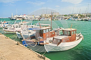 Small boats moored at port on sunny summer day