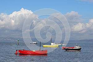 Small boats in Morecambe Bay at high tide.