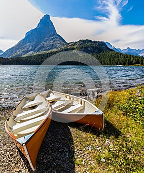 Small Boats On Swiftcurrent Lake With Mt. Grinnell