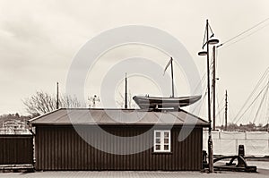 Small boatyard on the pier. Boat garage with boat on the roof