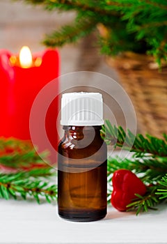 Small bottle of essential oil and fir branches. Christmas or Valentine`s gift. Aromatherapy, spa concept