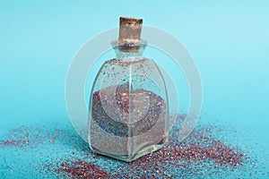 Small bottler with glitter on a green background