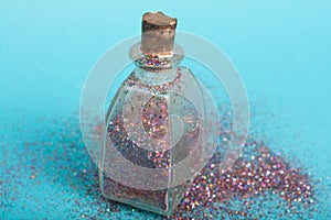 Small bottler with glitter on a green background