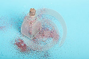 Small bottler with glitter on a green background