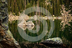 Small Boulder Reflects In The Green Of Haiyaha Lake