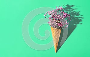 Small bouquet on a minty background. Pink flowers. Waffle
