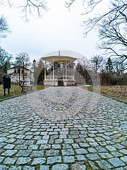 Small bower in old park at center of square