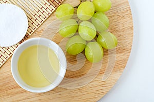 Small bowl with grape seed oil grape juice, vinegar. Ingredients for preparing homemade hair mask, face toner. Natural beauty